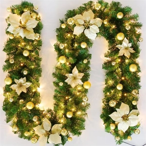 Classic Christmas garland with green pine needles, gold poinsettias, and LED lights on white