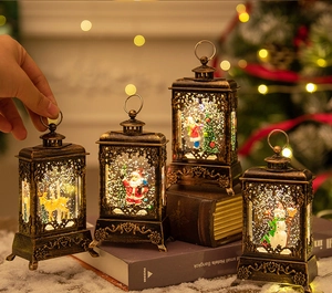 Close-up of four vintage bronze Christmas lanterns with snow globe effect and LED lighting