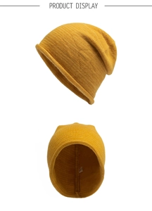 Detail view of ginger yellow knit beanie showing inner stitching and brand wash label