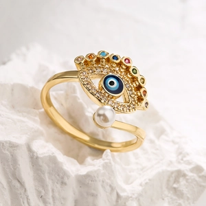 Gold plated evil eye open ring with multicolored zircons and a white pearl on white stone
