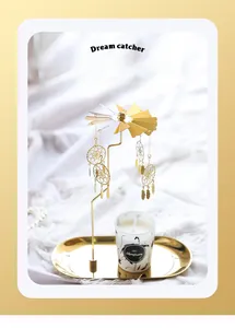 Close-up of golden dreamcatcher rotary candle holder with marble pattern scented candle