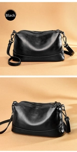 Detail of black lychee grain leather crossbody bag featuring a multi-zipper compartment