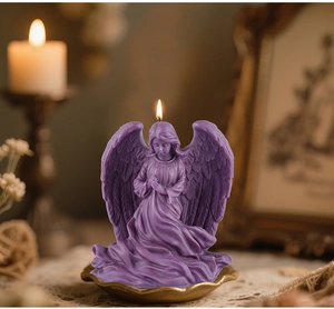 Detail view of purple angel shaped candle with intricate feather texture and golden base