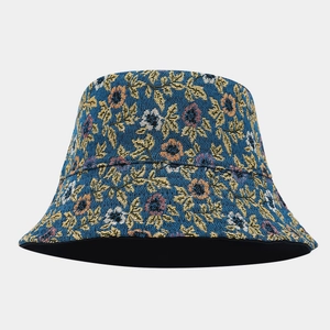Detail of high-density jacquard fabric on navy blue bucket hat with yellow leaf patterns