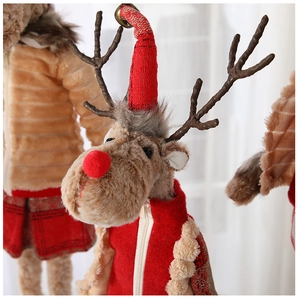 Close-up of plush Christmas reindeer with knitted red hat and textured bell details
