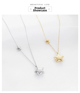 Detailed view of polished gold and silver star pendants on a delicate cable chain