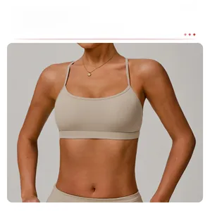 Detail of beige strappy sports bra with double shoulder straps and high-elasticity fabric