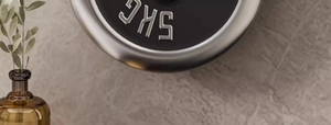 Detailed view of a 5kg coated metal dumbbell weight plate on a stone background