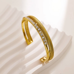 Detail of gold-plated double-layer open bangle with pavé zircons and wavy texture