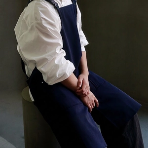 Waterproof cotton canvas apron in navy blue with pockets for cafe and kitchen work