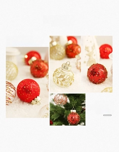 Detail of PET painted Christmas balls with red glitter and gold swirls for tree decor