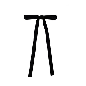 Detailed view of the soft black velvet fabric and elegant texture of the long ribbon bow
