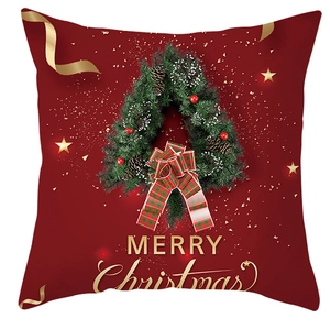 Detailed close-up of a festive Christmas wreath and golden Merry Christmas print on pillowcase