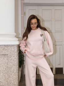 Pink two-piece knit set featuring long sleeve crewneck top with embroidery and wide-leg pants