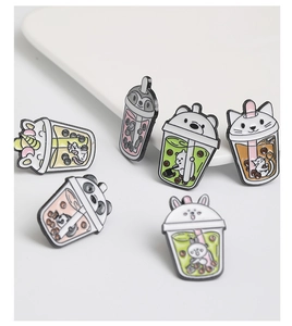 Detailed view of six cute animal enamel pins featuring pandas and rabbits in tea cups