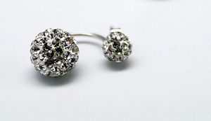 Macro shot of S925 sterling silver double-sided stud earrings with sparkling crystals
