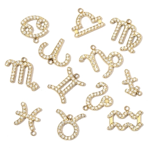 Close-up of gold-plated zodiac pendants set with sparkling cubic zirconia crystals