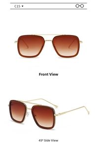 Close-up of gold metal aviator sunglasses with brown gradient lenses and textured frame