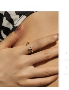 Close-up of gold geometric open ring with dual baguette and marquise cut zircon stones