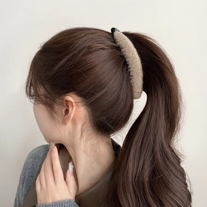 Detail of khaki flocking wool hair clip holding a ponytail shown from back view