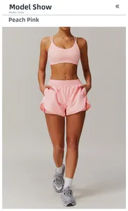 Detail view of peach pink yoga set with cross back bra and high-waist shorts for fitness