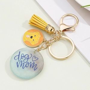 Detailed close-up of a resin keychain featuring dog mom lettering and a golden retriever charm