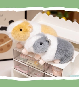 Detailed view of fluffy guinea pig plush toys in yellow and grey with realistic soft fur