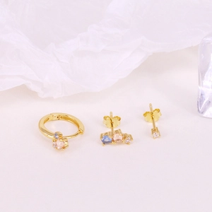 Detailed macro view of S925 sterling silver stamp on gold star and evil eye earring set
