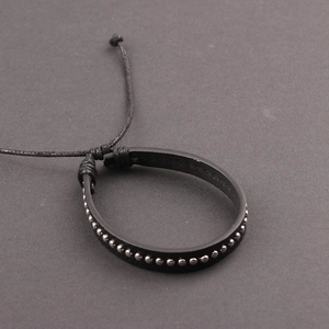 Men's punk black leather bracelet with silver metal rivets and adjustable knot closure