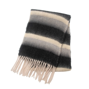 Detail of soft winter scarf featuring black and beige stripes with chunky fringe tassels