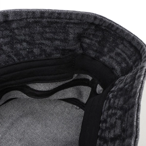 Detail of high-quality denim bucket hat showing neat black stitching and sweatband