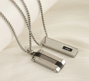 Close-up of hip-hop style rectangular pendants with silver and black metallic details