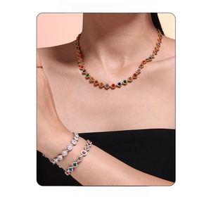 Close-up of layered colorful zircon necklace and sparkling tennis bracelets on model