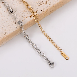 Polished stainless steel bracelet with embossed hollow cylindrical beads in silver and gold