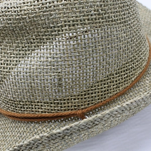 Detailed close-up of the breathable open-weave pattern and brown rope on a cowboy straw hat