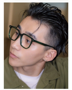 Detail view of retro dark green square frame glasses on male model for face slimming effect
