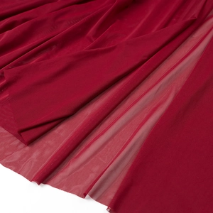 Close-up of deep red mesh fabric texture showing sheer quality and elegant draping