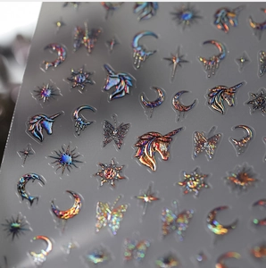 Macro detail of 3D laser nail stickers with holographic unicorn and butterfly patterns