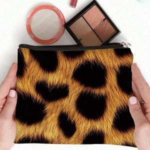 Leopard print canvas cosmetic bag with zipper, held by hands with makeup accessories