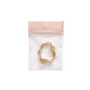 Golden twisted wavy hoop earring in a transparent EVA protective storage bag