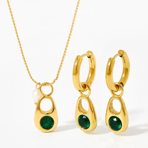 Gold stainless steel jewelry set featuring green gemstone pendants and a white pearl accent