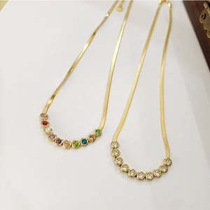 Detail of gold snake chain necklaces with colorful and white round zircon inlays
