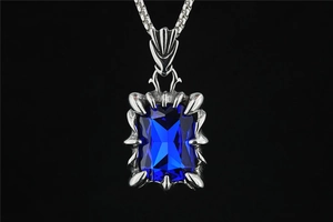 Close-up of dragon claw pendant featuring a square blue gemstone in silver titanium steel