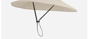 Detail of beige outdoor sun hat showing lightweight fabric and black windproof drawstring