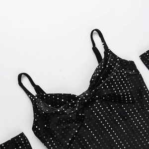 Detail of black sequin dress featuring polka dots and a large bow on the neckline