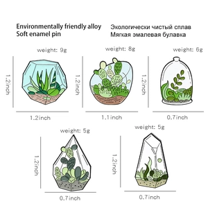 Detailed macro view showing five creative terrarium plant enamel brooches on white