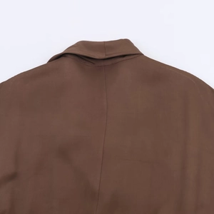 Détail du col drapé et des coutures sur un tissu de robe midi marron élégante