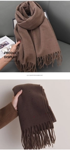 Detailed view of brown cashmere-like scarf with colored dots and elegant long tassels