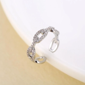Silver adjustable twist ring featuring paved cubic zirconia in a linked chain style design