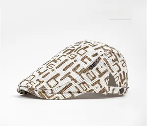 Close-up of breathable linen straw flat cap featuring brown graffiti print and metal logo